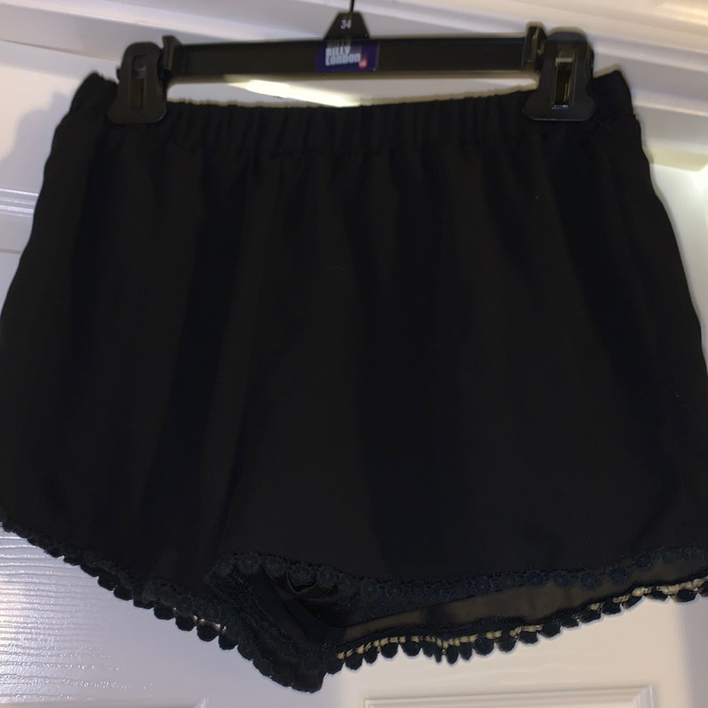 Black flowy shorts with design at bottom